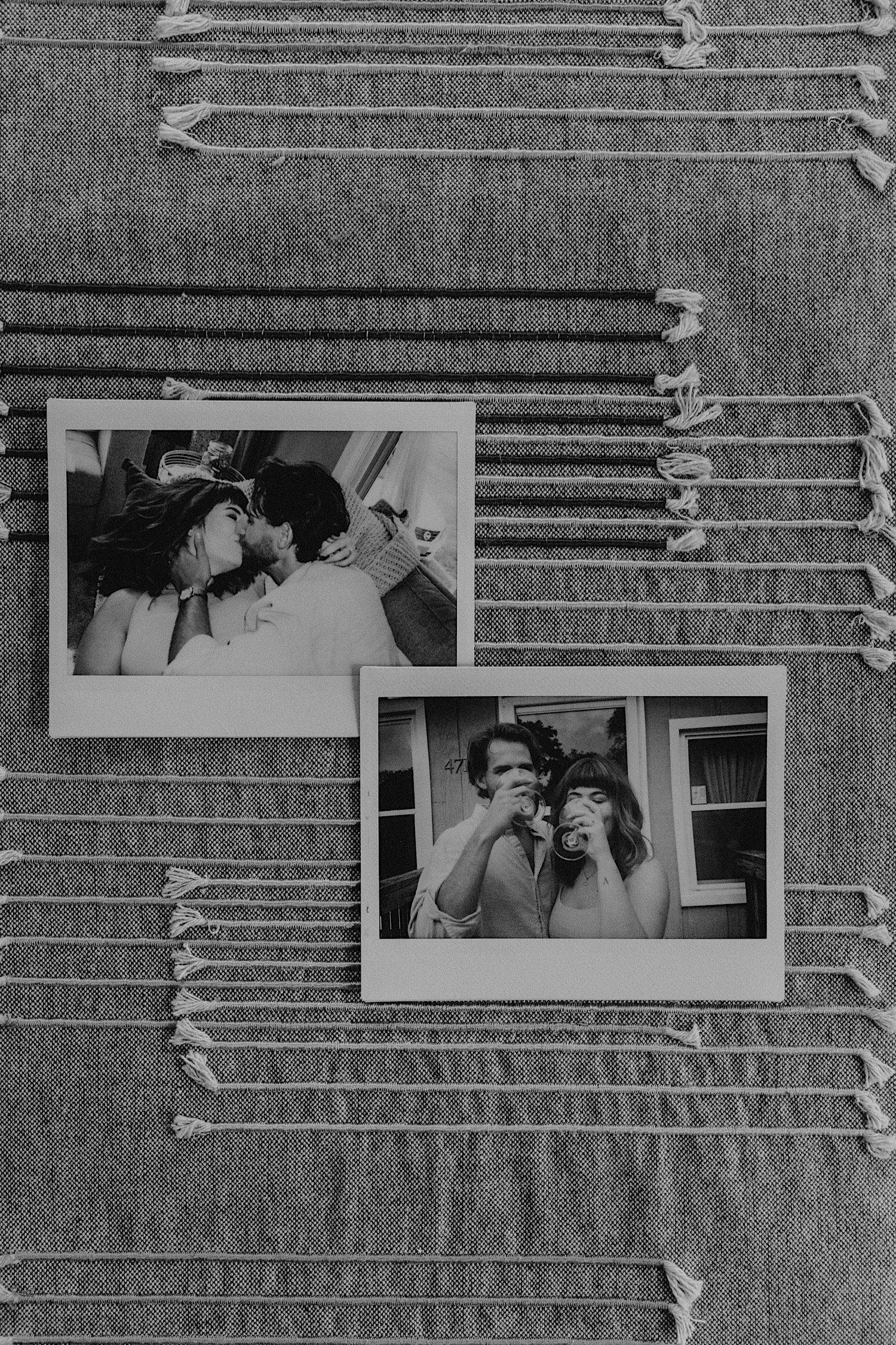Polaroids of a couple kissing on the couch, sipping wine on their front porch sitting on a placemat on their kitchen table.