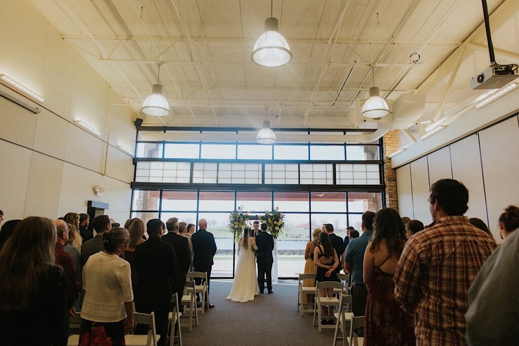 A wedding ceremony taking place at the indoor ceremony space at Erin's Pavilion in Springfield Illinois