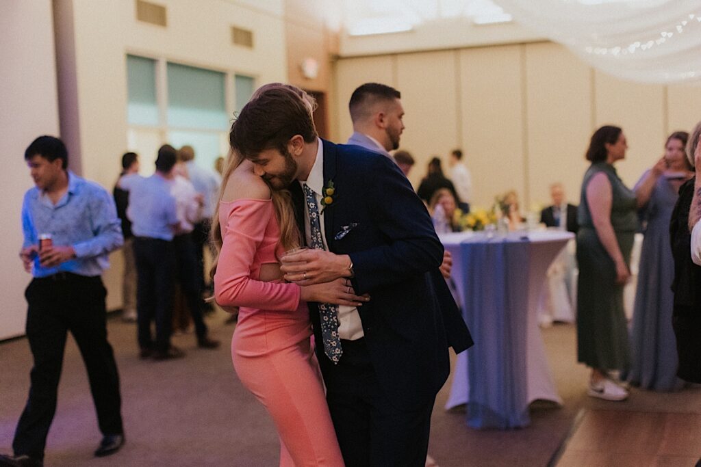 Two guests of a wedding reception at Erin's pavilion embrace during the dancing portion of the evening