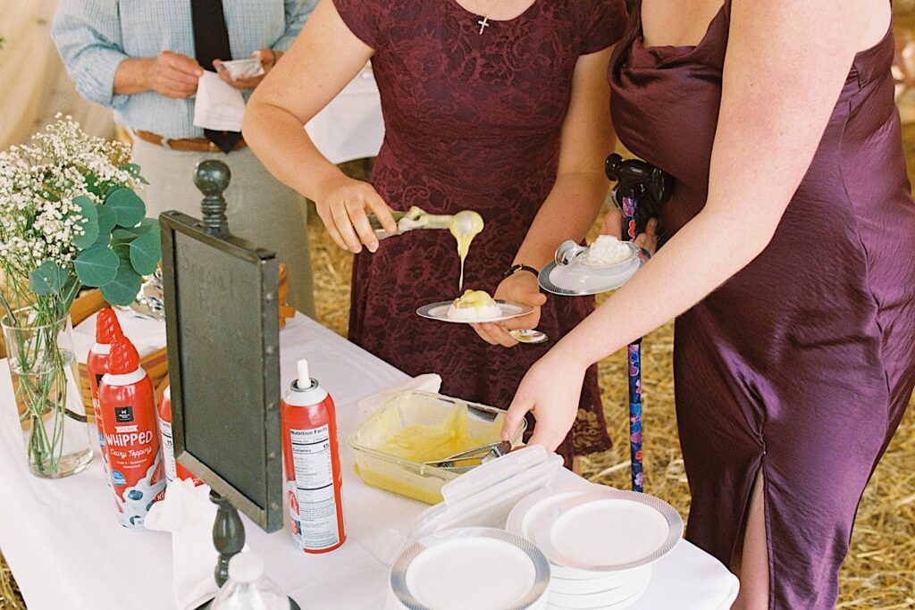 Film photo of a guest at a wedding putting desert on their plate