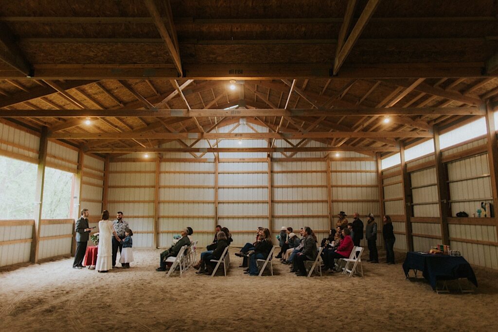 A wedding ceremony taking place in a barn in the bride and groom's backyard in Springfield Illinois
