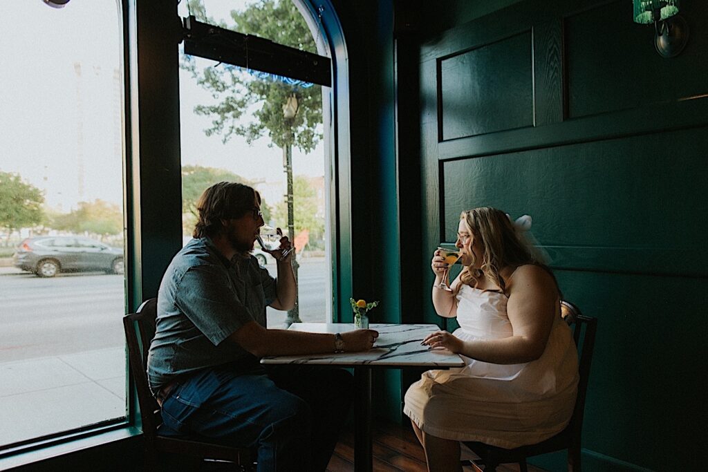 A couple sit at a table for a drink at The Wakery in downtown Springfield during their engagement session