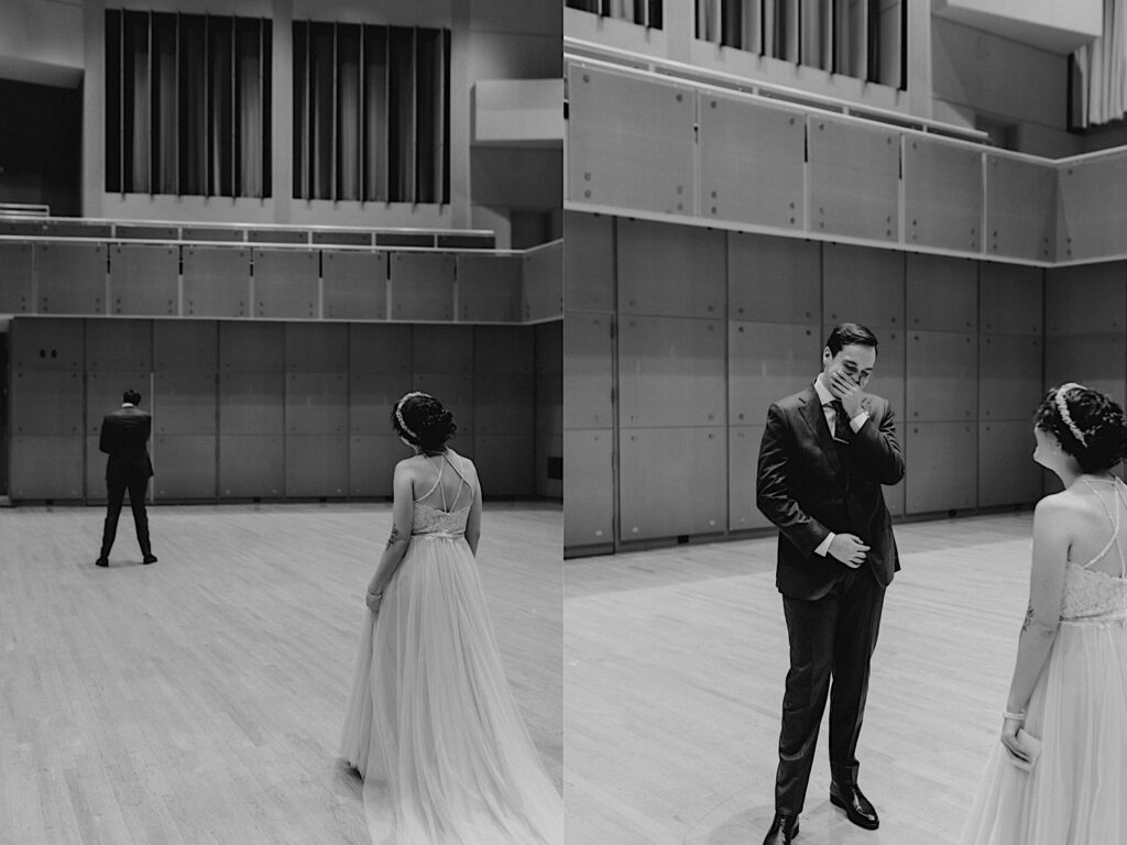 2 photos side by side in black and white of a bride and groom in a large room, the left is of both the bride and groom facing away from the camera with the bride closer to the camera before their first look, the right is of the groom reacting to seeing the bride for the first time