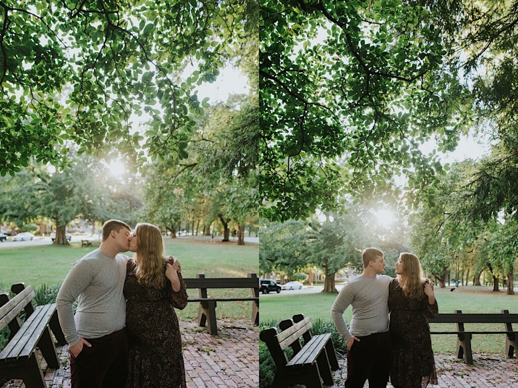 2 side by side photos of a man and woman standing next to one another in a park each with an arm wrapped around the other. In the right photo they are kissing and in the left they are looking at one another
