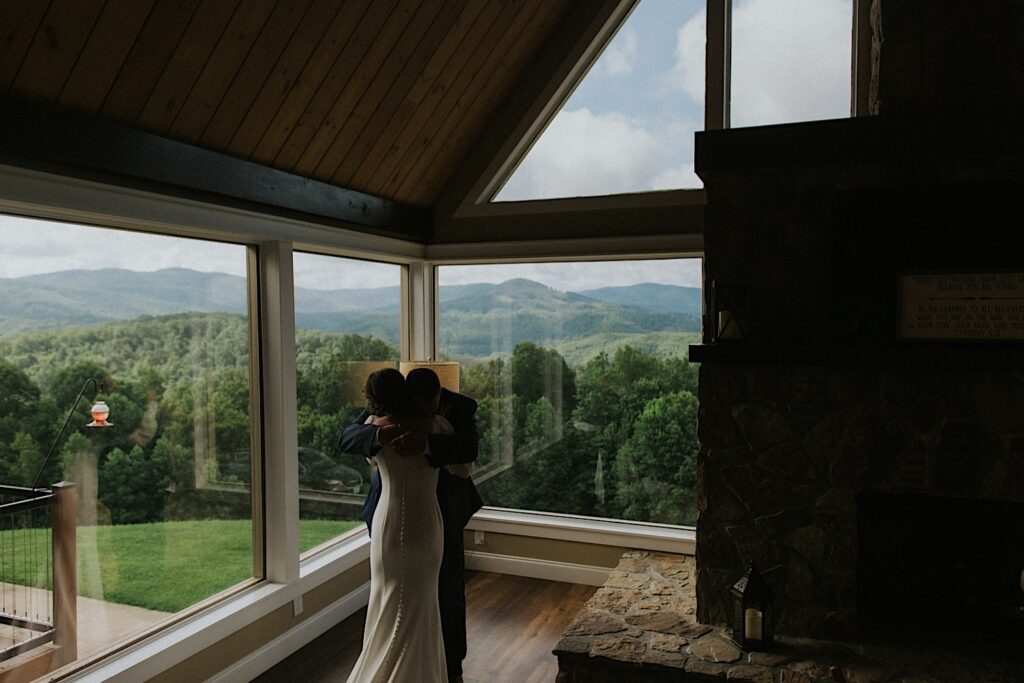 A bride and her father hug one another during a first look prior to the bride's intimate destination wedding in Tennessee