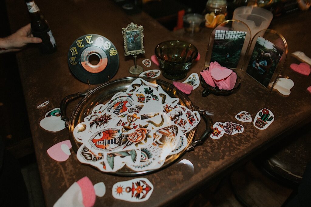 A bowl of temporary tattoos sits on a table ready for guests of a wedding to chose from