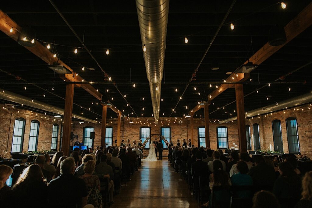 A wedding ceremony takes place inside of Trailside Event Center