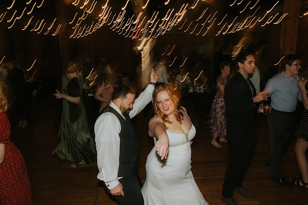 A bride and groom dance together during their wedding reception at Trailside Event Center
