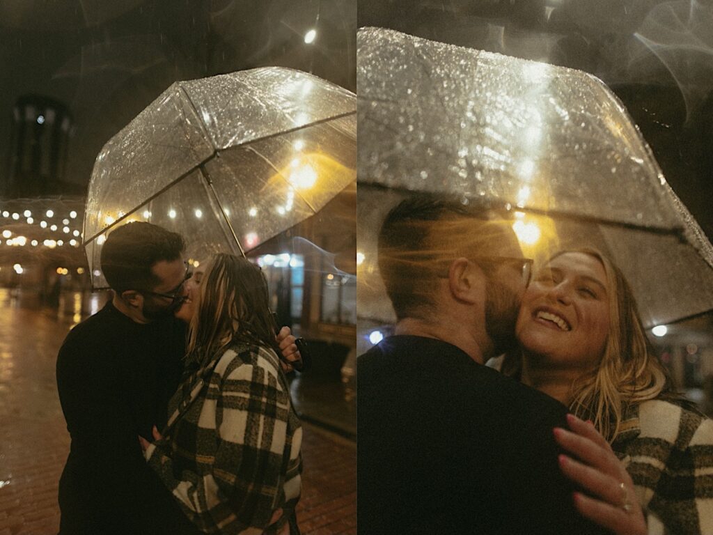 Couple kisses under a clear umbrella in the rain surrounded by lights in downtown Springfield, Illinois. 
