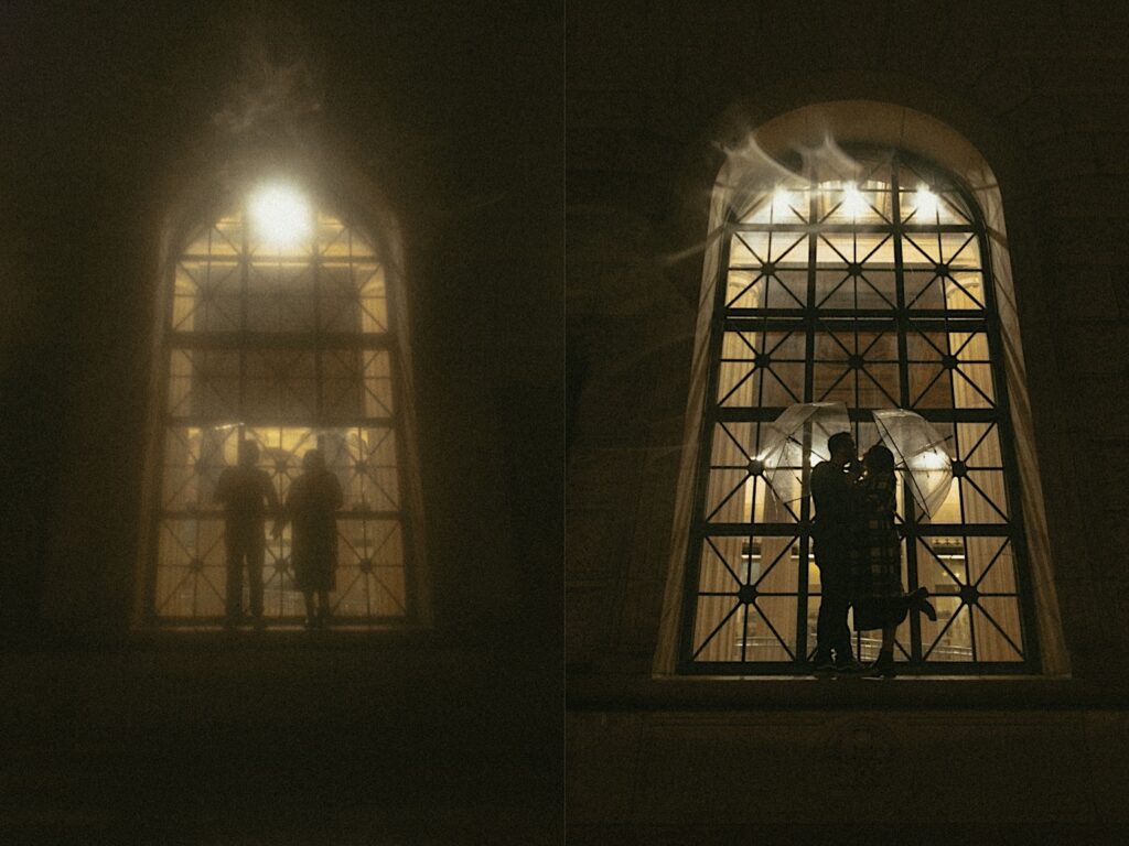 Couple silhouette stands in front of lit up building in downtown Springfield during a rainy couples photo session. 