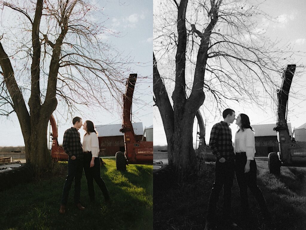 Man in plaid shirt holds girl in white shirt with farm background during engagement photoshoot in Springfield Illinois