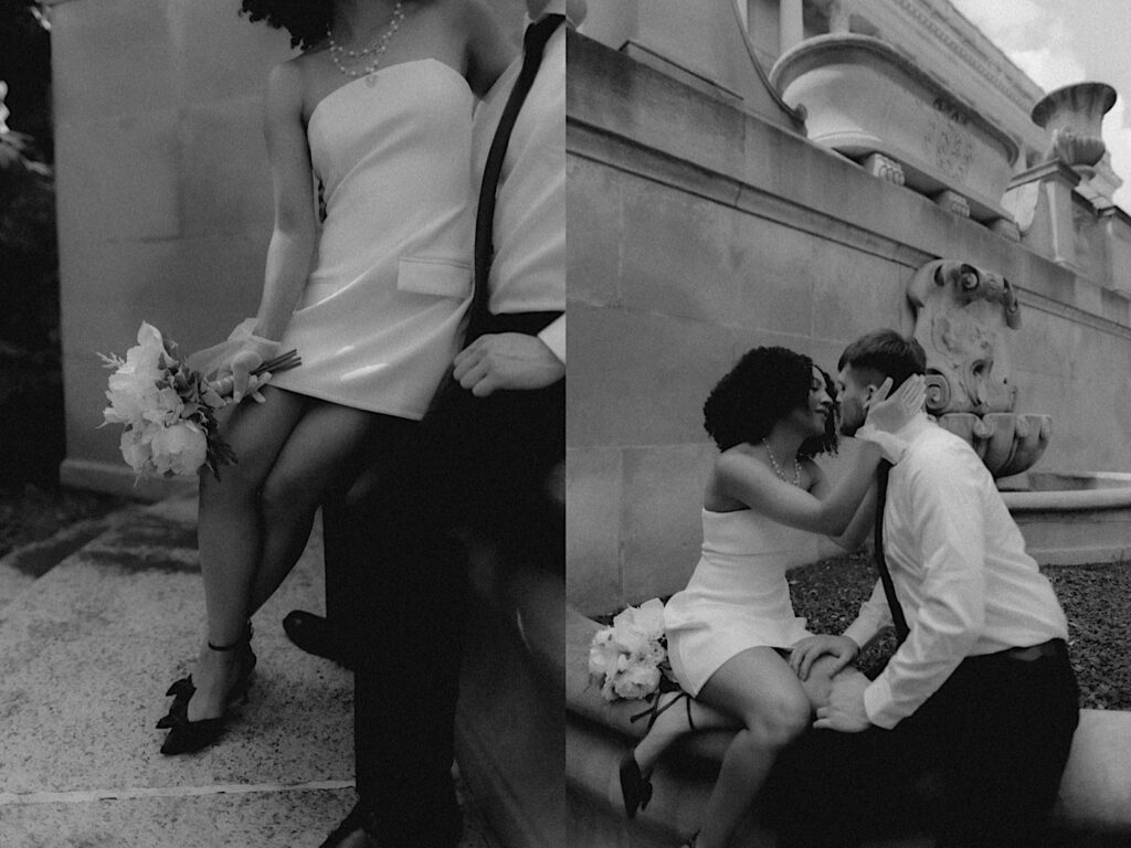 Springfield Elopement Photographer captures the bride and groom in a timeless black and white filmy portrait. They are sitting on a ledge leaning in for a kiss with the Springfield Courthouse in the background. 