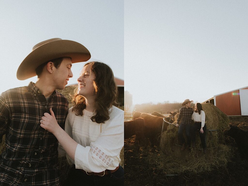 Couple sits on hay with a red barn in the background during golden hour for an engagement session on a farm in Springfield Illinois. 