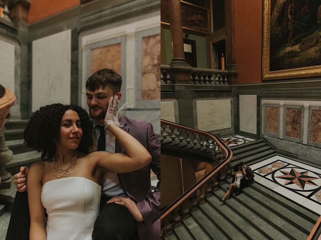 Springfield elopement photographer captures a wide shot from a floor above the couple of bride and groom sitting on marble staircase while they kiss during elopement portraits. 