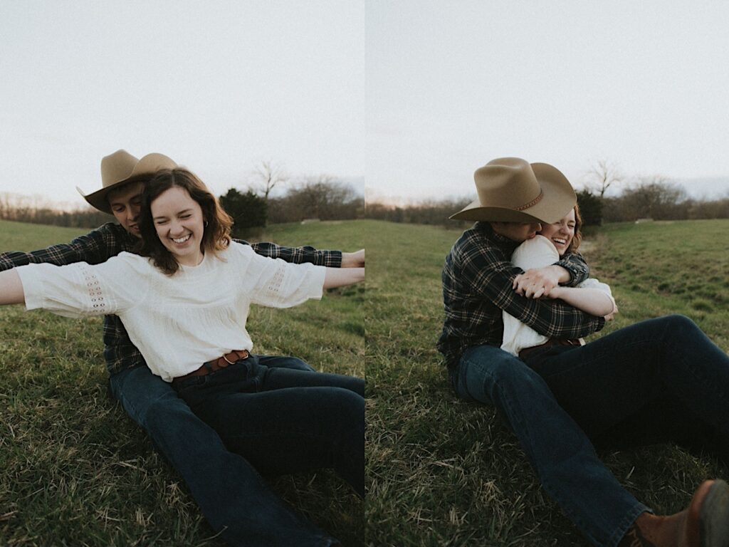 Man with cowboy hat sits and hugs girl on grass for cozy engagement photos in Springfield, Illinois. 