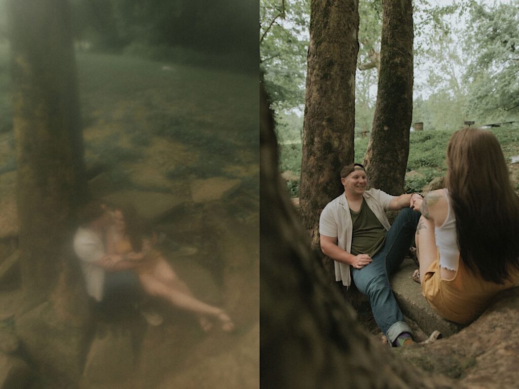 Illinois Engagement Photographer captures a trendy fuzzy portrait of a woman sitting on her fiancé's lap underneath a tree in a forested park in Lincoln, Illinois. 