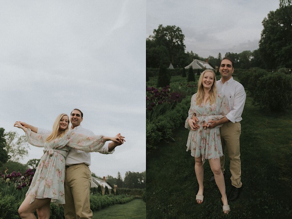 Woman stands as her fiance holds her from behind with beautiful greenery in the background. 