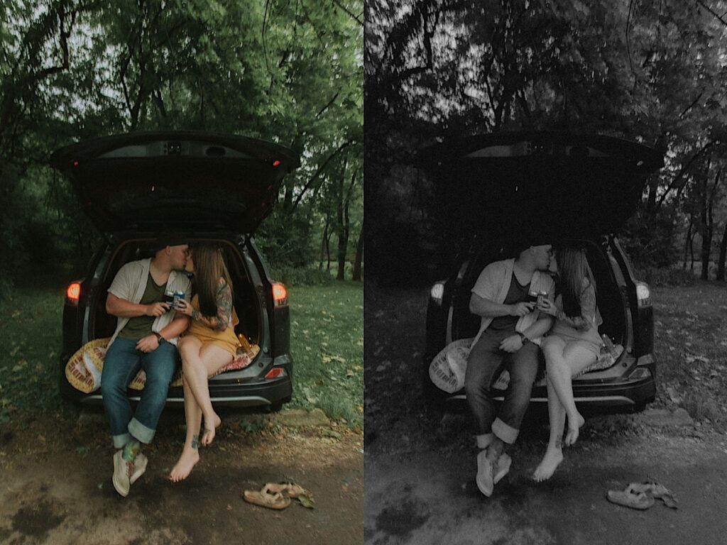 Couple sits on the back of the trunk of their car on a quilt kissing and clinking their Old Style Beer for a Cheers. 