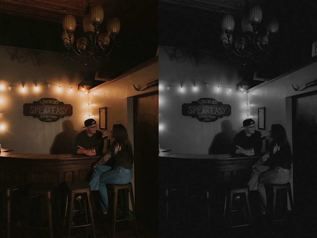 Girl in jeans sits on a barsttol with her elbow on a bar while her fiancé stands behind the bar and leans towards her. In the background is a sign that reads, Lincoln Speakeasy. 