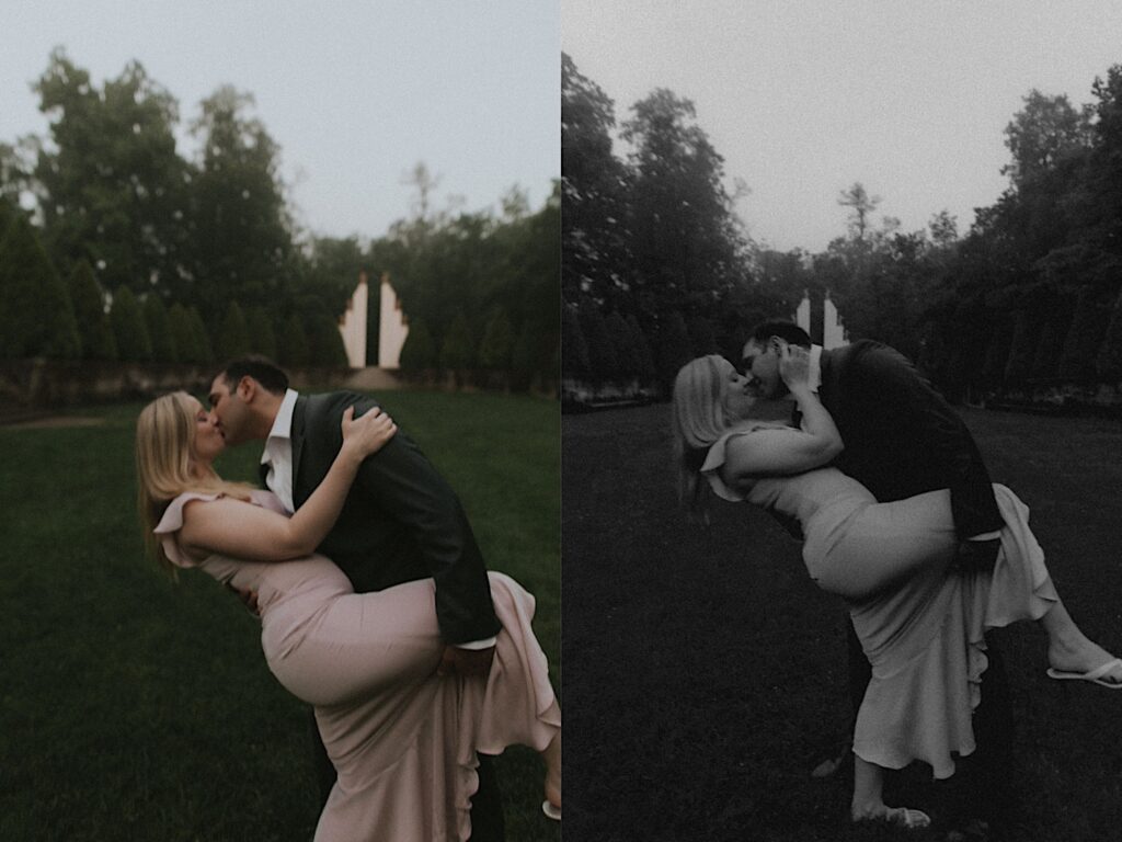 Man dips his fiancee while holding her leg for a kiss in a grassy yard during engagement portraits in Allerton Park. 