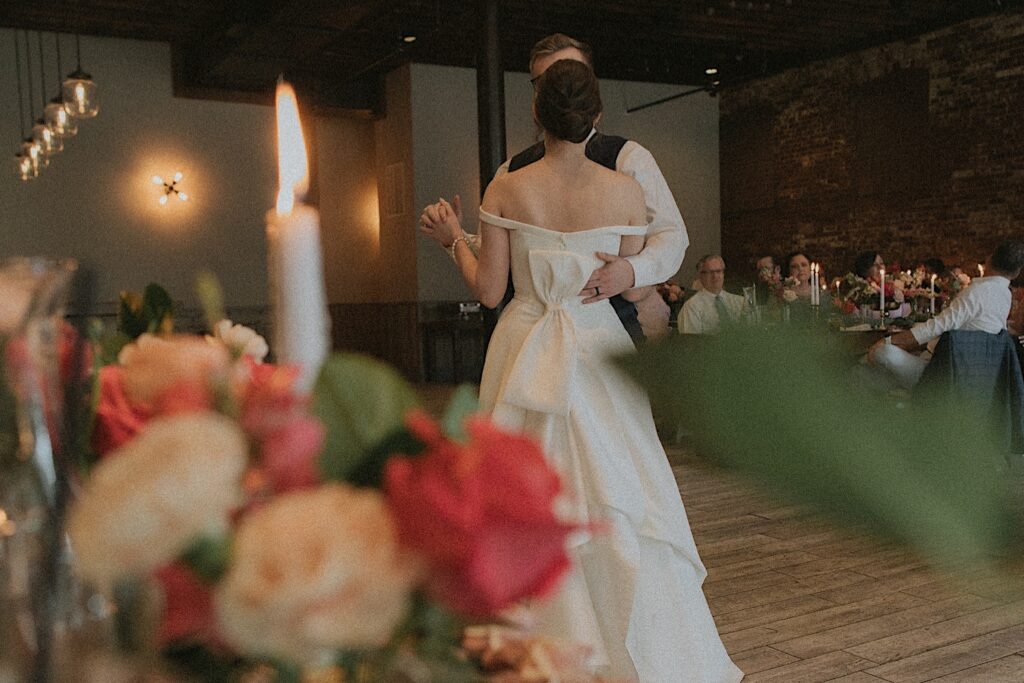 Bride and her father dance in the center floor in reception hall at Reality on Monroe. 