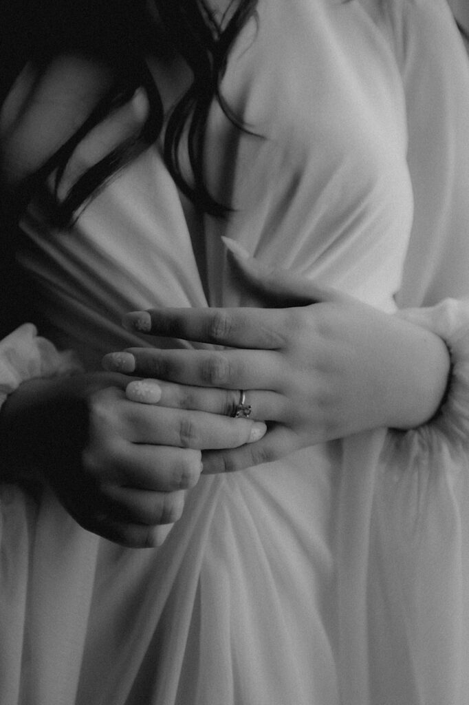 Central Illinois wedding photographer captures a close up of bride holding her hands together detailing her engagement ring. 