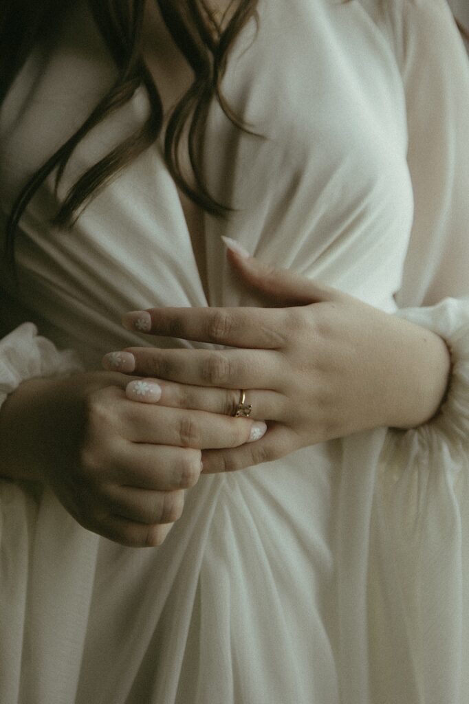 Central Illinois wedding photographer captures a close up of bride holding her hands together detailing her engagement ring. 