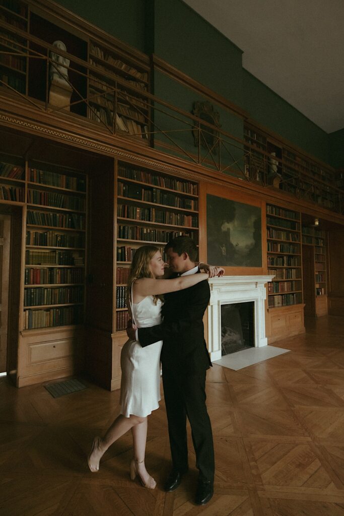 A bride and groom have a moment on their elopement day in the Allerton park library.  