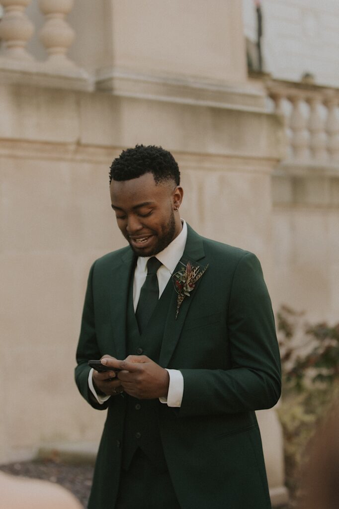 A groom stands on the steps of the Illinois State Capitol 