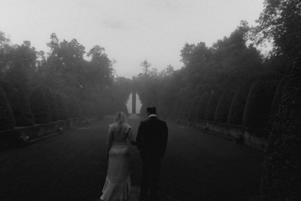 Couple is walking through Allerton Park, an Illinois elopement location, before saying their vows. 