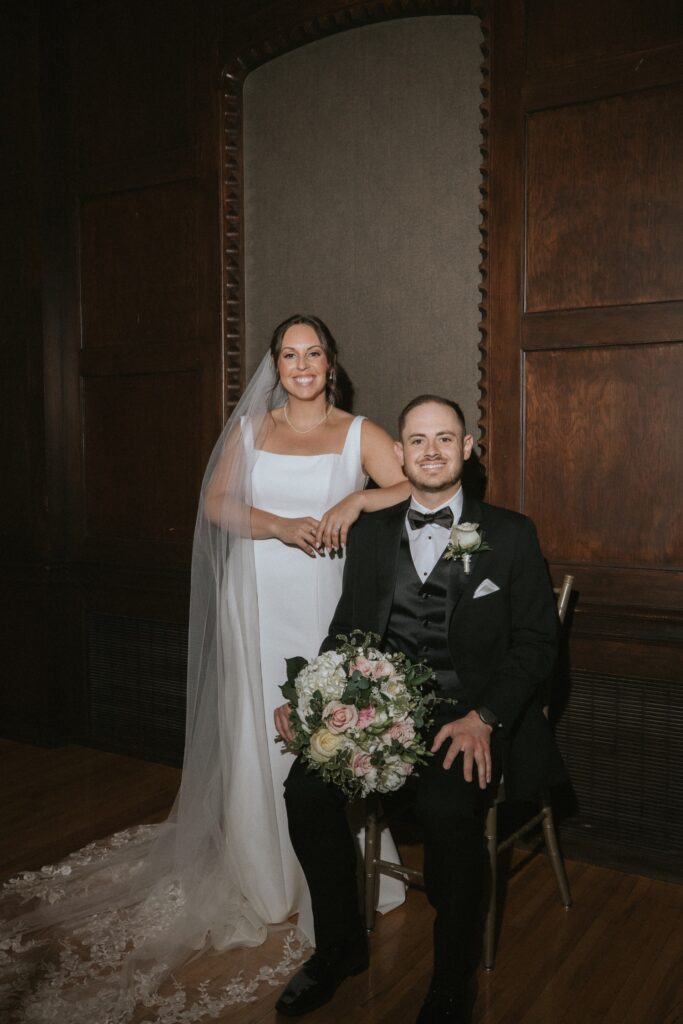 A bride and groom smile for a portrait during their black tie wedding at their Chicago suburbs wedding at the Chevy Chase Country Club. 