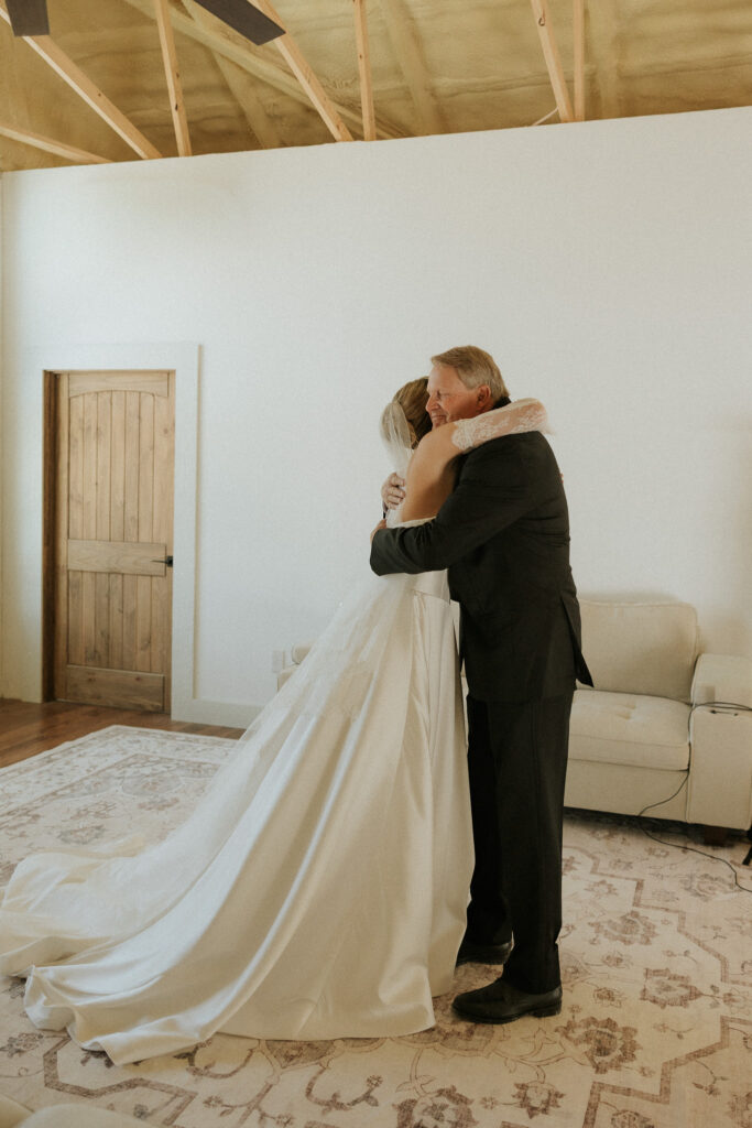 father of the bride hugs daughter at  The Hilltop Barn, a new wedding venue in Central Illinois